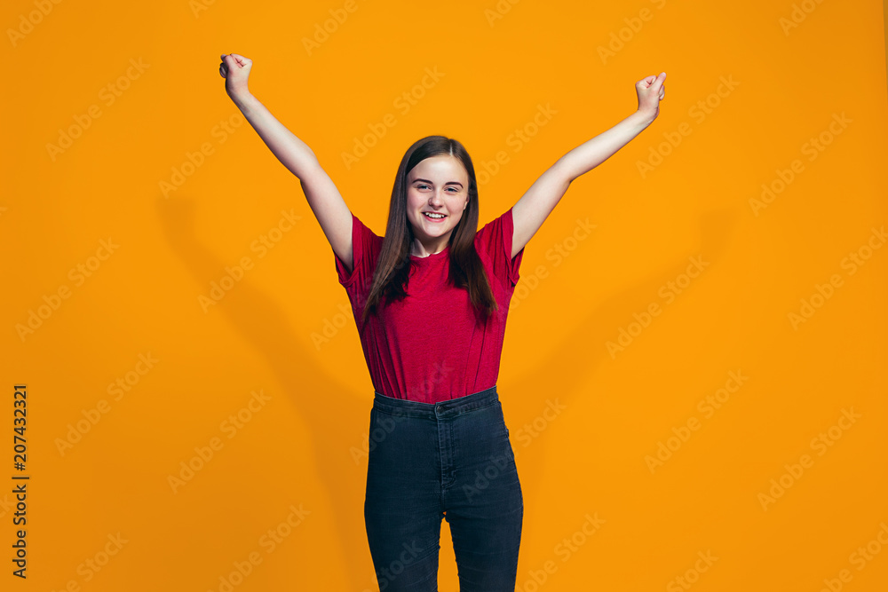 Happy success teen girl celebrating being a winner. Dynamic energetic image of female model Happy success teen girl celebrating being a winner. Dynamic energetic image of female model