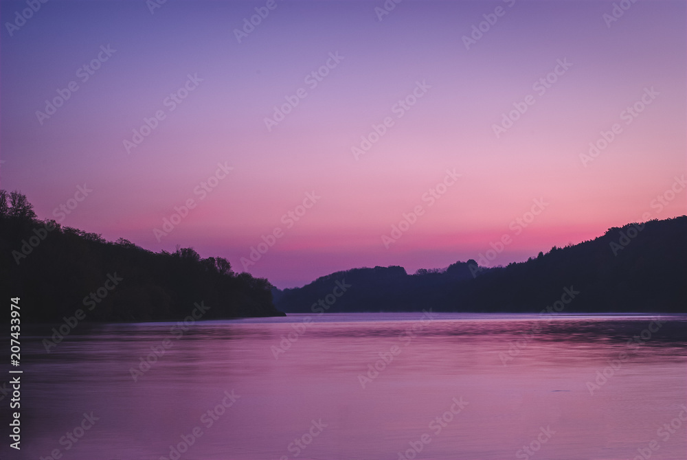 Fototapeta premium Beautiful sunrise over the river reflected sky in the river