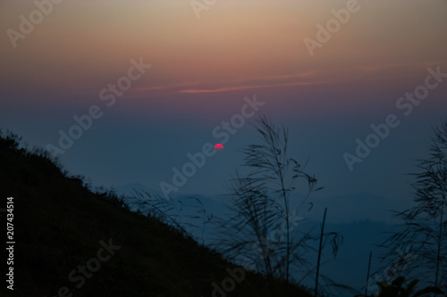 Light sunset behind the mountains Nern Chang Suek  hills, Kanchanaburi, Thailand photo