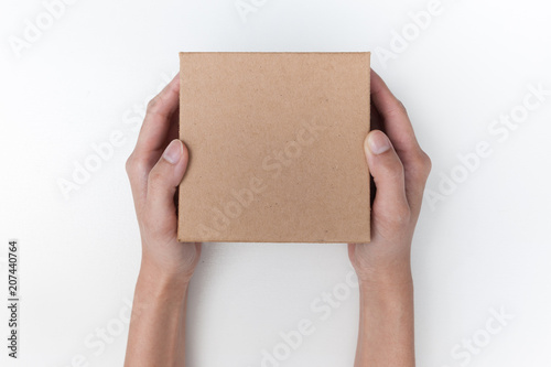 female hand holding gift box. Isolated on white background. © aradaphotography