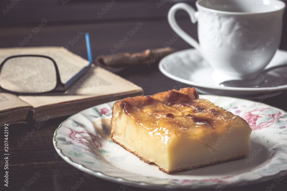 Sweet homemade apple cake and coffee. Breakfast and reading on rustic wooden table. Sweet homemade apple cake and coffee. Breakfast and reading on rustic wooden table.