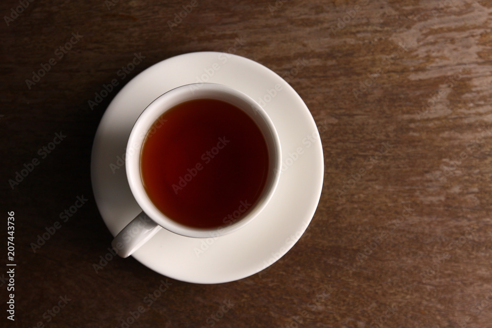White tea glass on wooden table top corner. Have space White tea glass on wooden table top corner. Have space