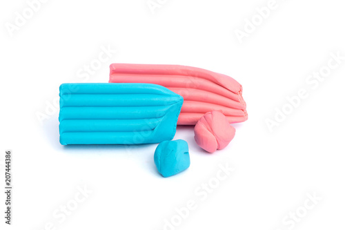 Red, blue, pink, pieces of plasticine on a white background. photo