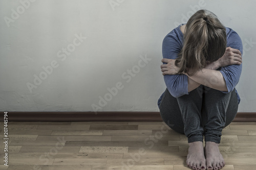 Depressed with a woman. The girl is sad in the room.