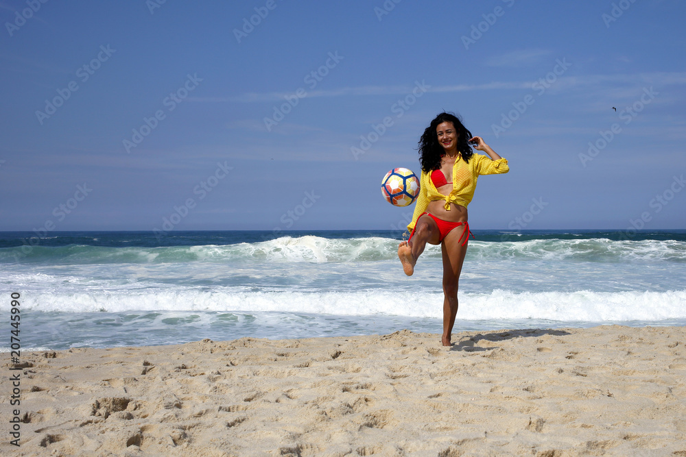 Woman playing ball on the beach