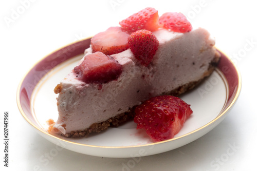 slice of strawberry cheesecake on white background, selective focus