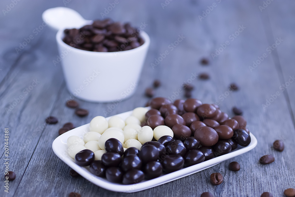 Grains of coffee in glaze of white, milky, and dark chocolate. Grains of coffee in glaze of white, milky, and dark chocolate.
