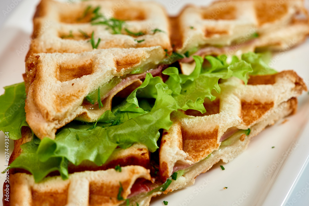 Waffle sandwich with ham and salad./Crispy sandwich with ham and salad. Breakfast. Waffle sandwich with ham and salad./Crispy sandwich with ham and salad. Breakfast.