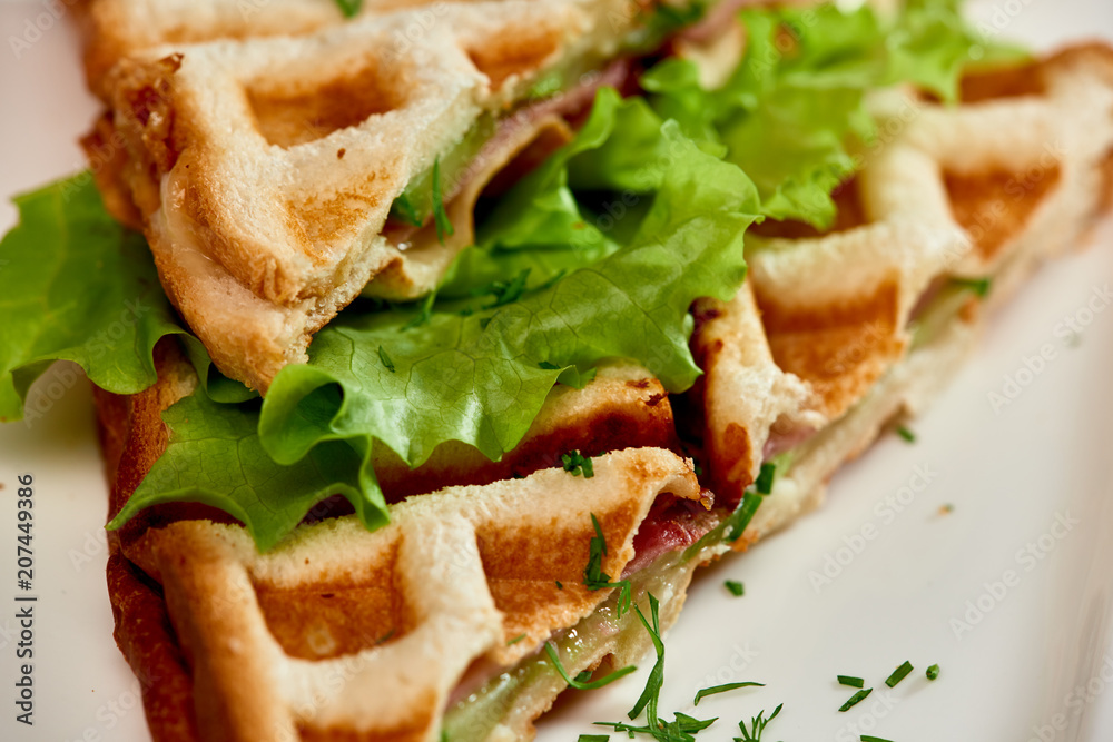 Waffle sandwich with ham and salad./Crispy sandwich with ham and salad. Breakfast. Waffle sandwich with ham and salad./Crispy sandwich with ham and salad. Breakfast.
