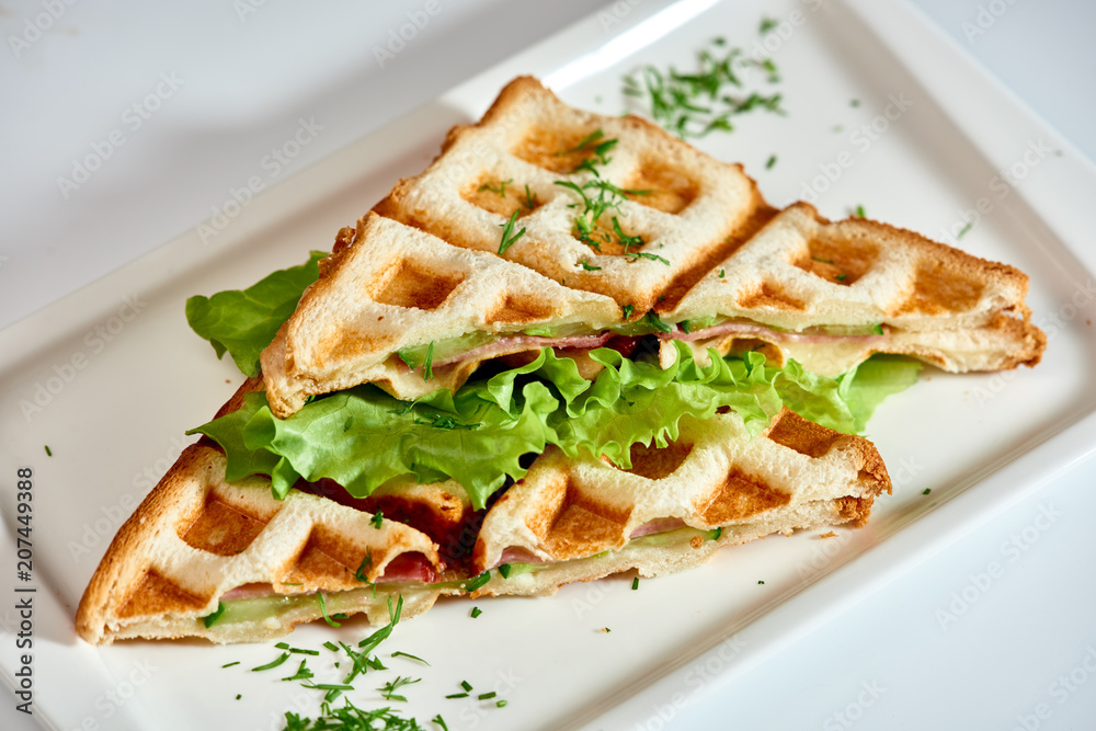 Waffle sandwich with ham and salad./Crispy sandwich with ham and salad. Breakfast. Waffle sandwich with ham and salad./Crispy sandwich with ham and salad. Breakfast.