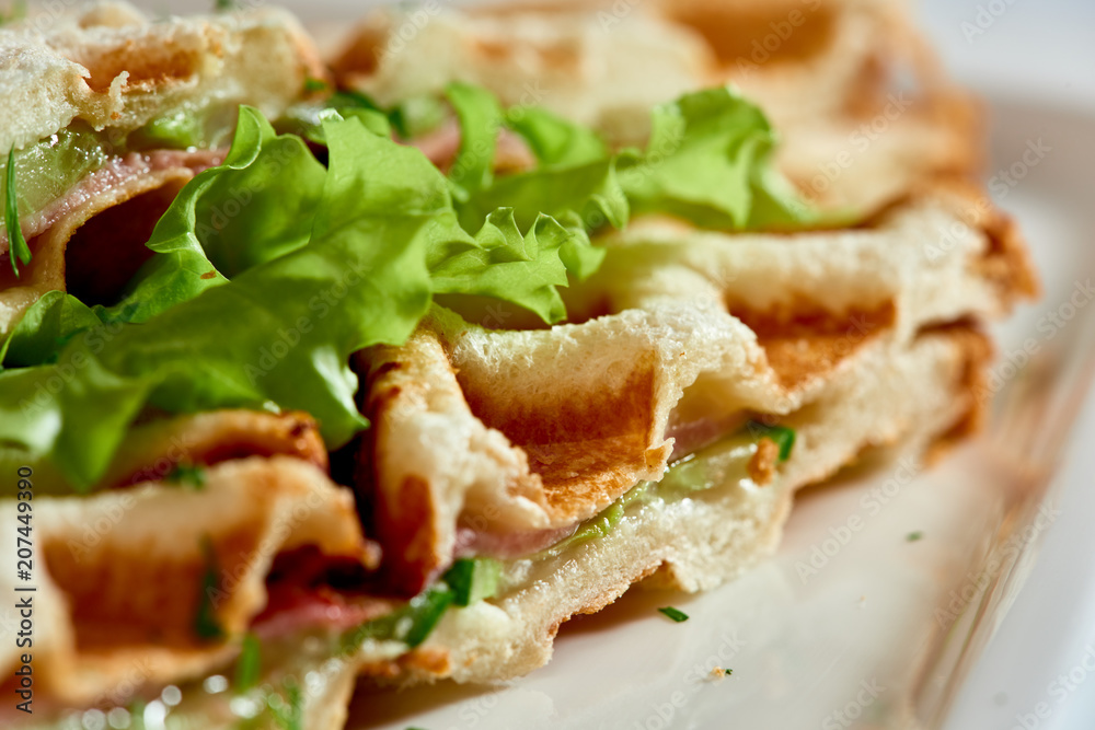 Waffle sandwich with ham and salad./Crispy sandwich with ham and salad. Breakfast.