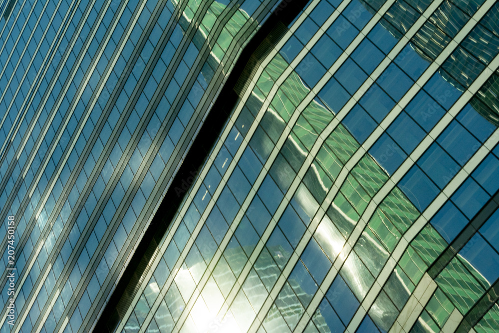 reflection of a tower of a skyscraper in a glass building of another skyscraper reflection of a tower of a skyscraper in a glass building of another skyscraper