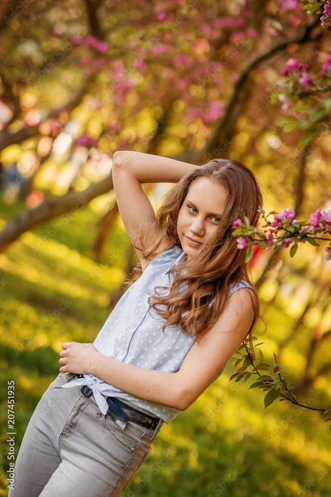 Portrait of a beautiful smiling girl with beautiful long hair in spring garden. Portrait of a beautiful smiling girl with beautiful long hair in spring garden.