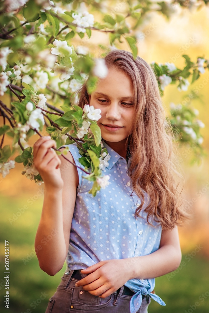 Portrait of a beautiful smiling girl with beautiful long hair in spring garden. Portrait of a beautiful smiling girl with beautiful long hair in spring garden.