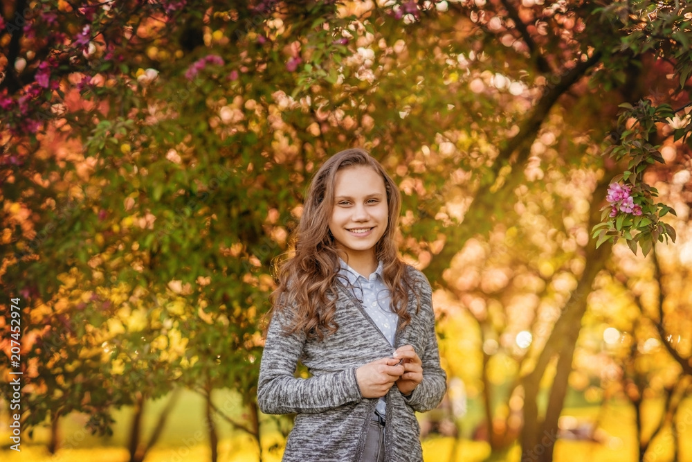 Portrait of a beautiful smiling girl with beautiful long hair in spring garden. Portrait of a beautiful smiling girl with beautiful long hair in spring garden.