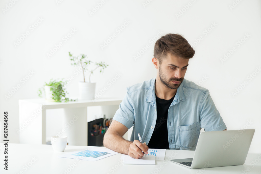 Serious financial manager working at laptop in office, analyzing company statistics, comparing diagrams, evaluating business progress, browsing web looking for information. Serious financial manager working at laptop in office, analyzing company statistics, comparing diagrams, evaluating business progress, browsing web looking for information.