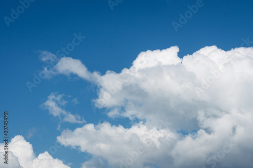 white cumulus clouds on blue sky background