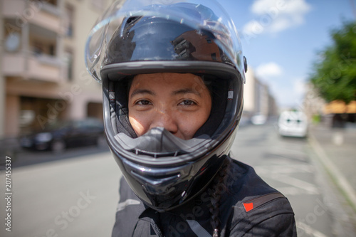 Woman with a black helmet on a motorbike © filmbildfabrik