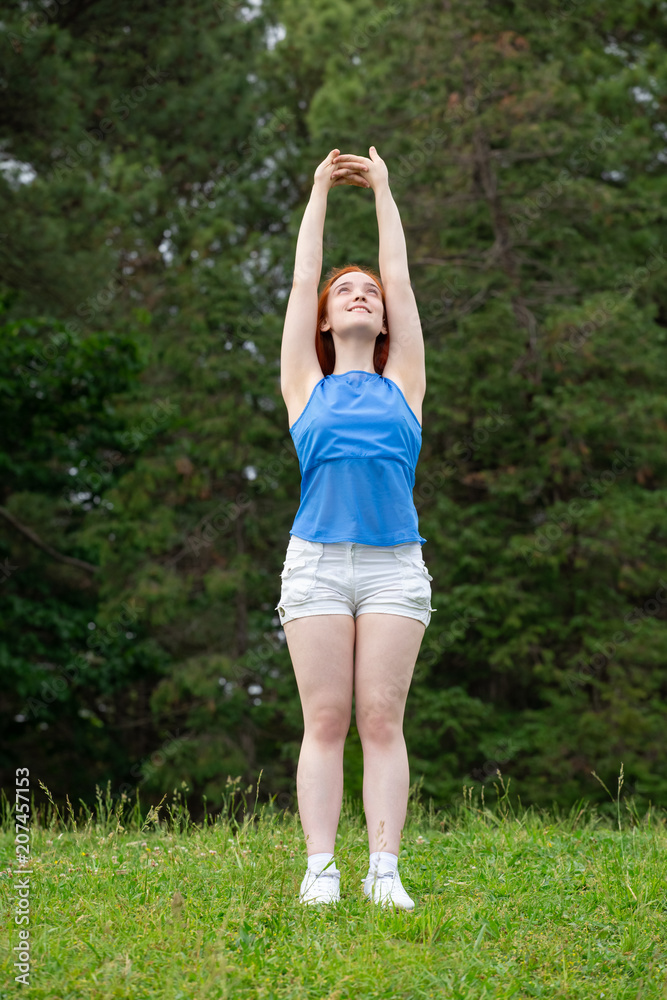 a girl is doing sports exercises in the park a girl is doing sports exercises in the park