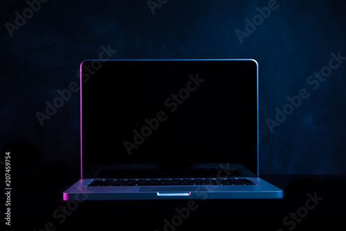 Portable modern silver computer on a black background.
