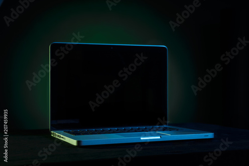 Portable modern silver computer on a black background.