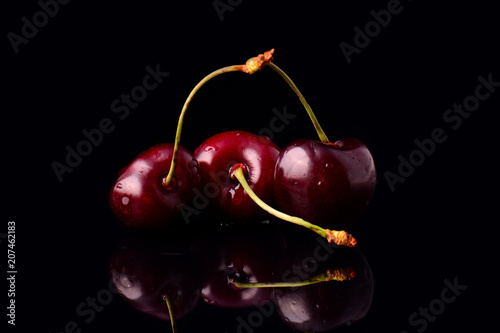 Red cherries on black background