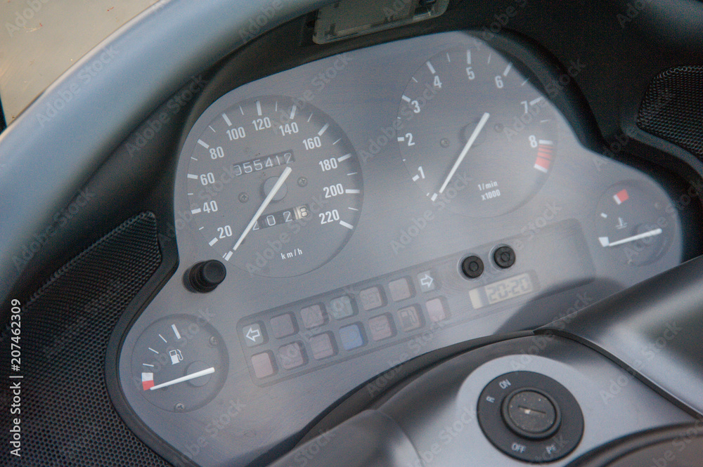 three part, red color dashboard of the car and kilometer gauge.