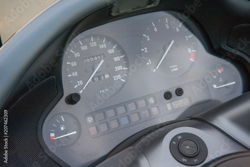 three part, red color dashboard of the car and kilometer gauge.