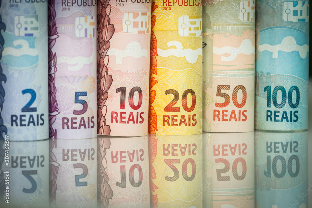 Brazilian money reflecting in the white glass. Brazilian money reflecting in the white glass.