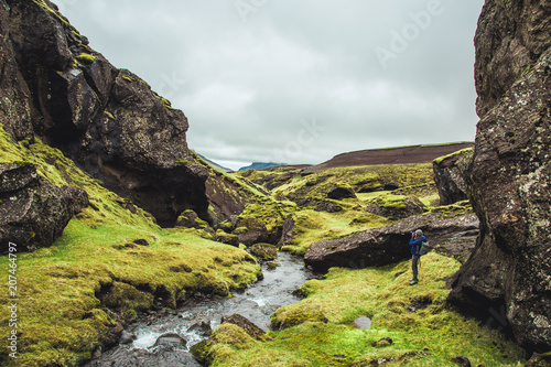 Woman hiking wild interior of Iceland.