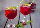 Red alcohol cocktail with berries 