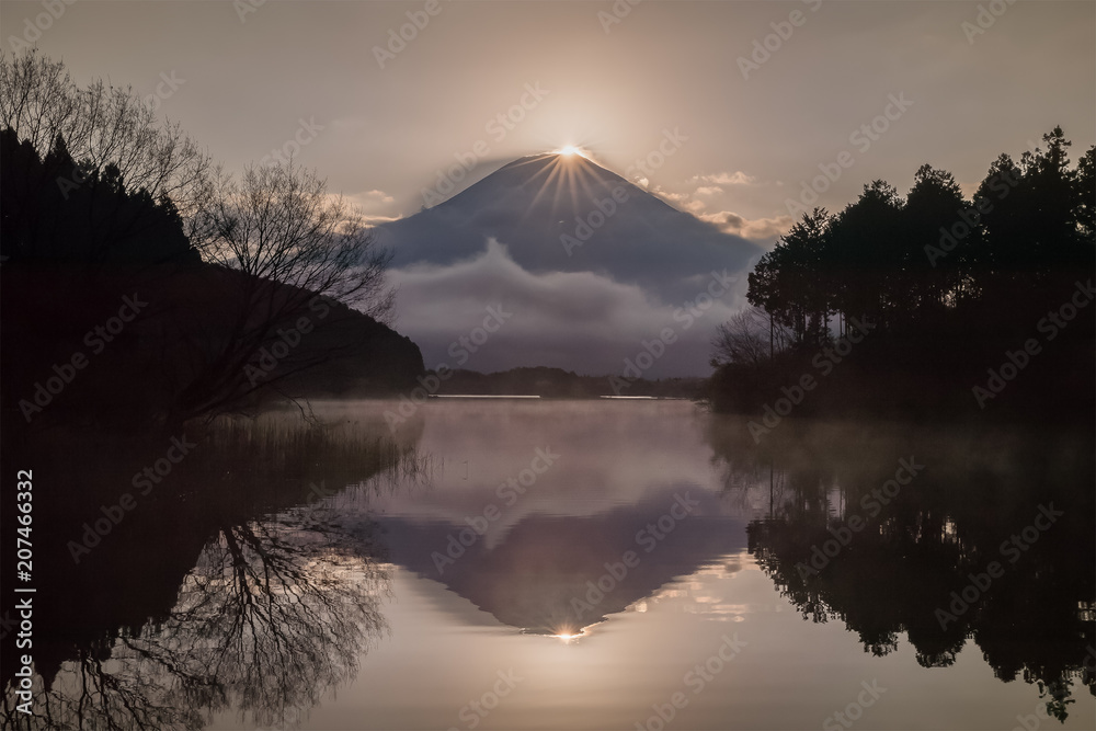 Diamond Fuji at Tanuki lake in morning spring season. Diamond Fuji is the name given to the view of the setting sun meeting the summit of Mt. Fuji.