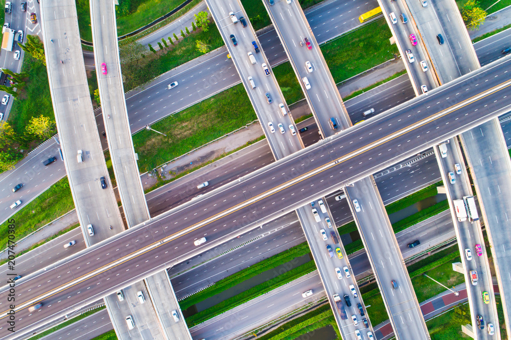 Aerial view car movement on traffic junction road with green tree park Aerial view car movement on traffic junction road with green tree park