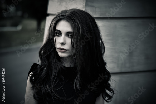 Gothic young brunette woman outdoors, shallow depth of field