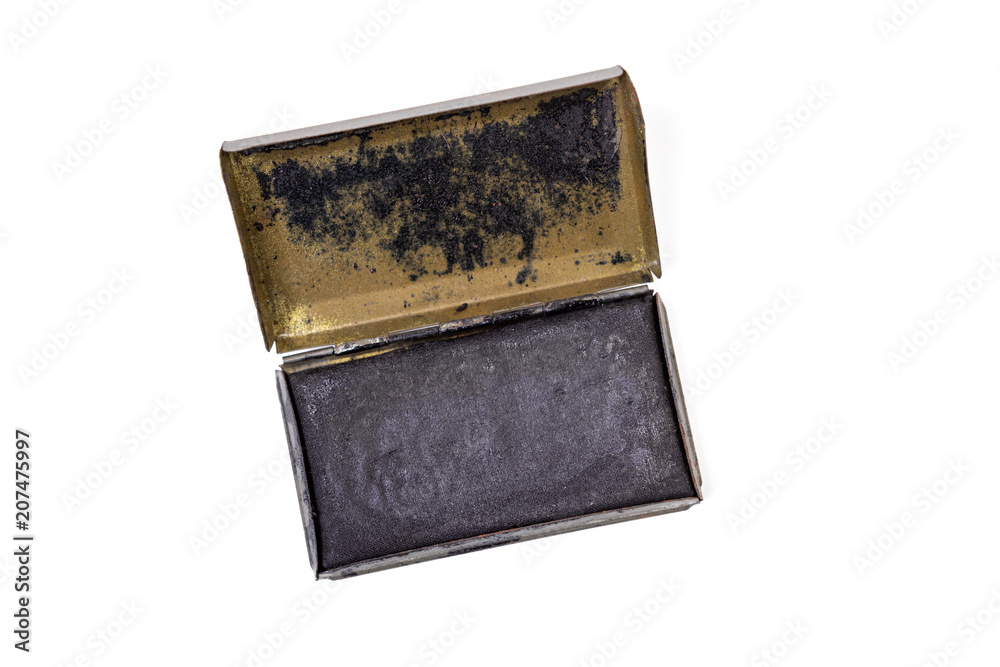 Obraz premium Vintage ink pad in a metal case, likely used in the US Army World War II, isolated on white
