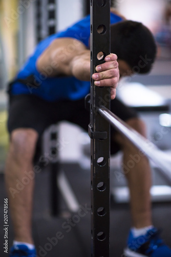 man doing pull ups on the vertical bar