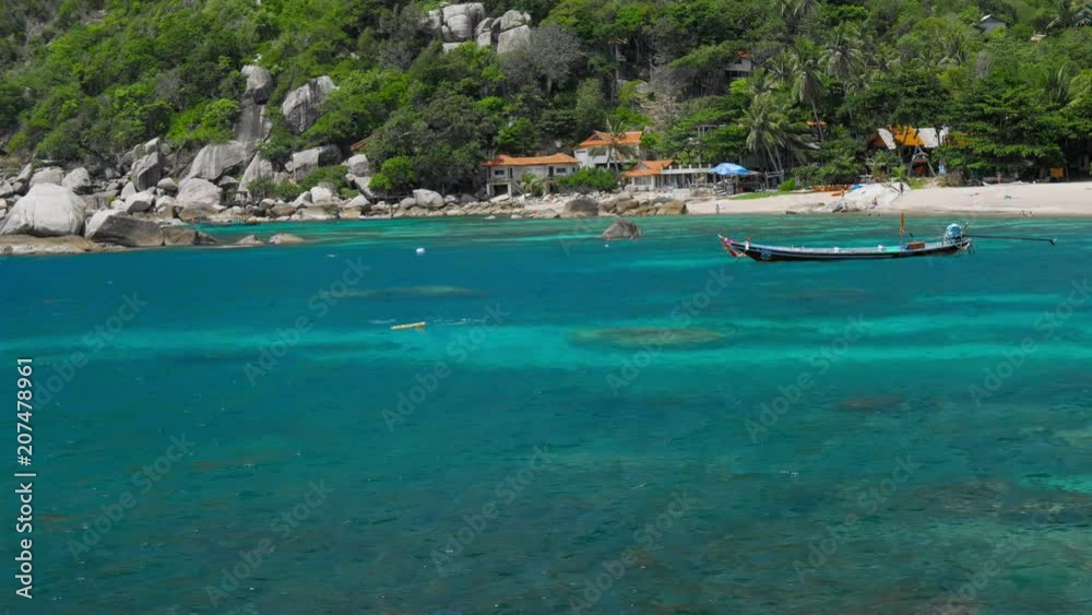 Tanote Bay on sunny day. Rippled ocean water over beautiffull Coral Reef. Divers practice in the blue bay. Koh Tao, Thailand Tanote Bay on sunny day. Rippled ocean water over beautiffull Coral Reef. Divers practice in the blue bay. Koh Tao, Thailand