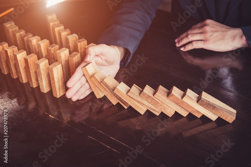 Business man placing wooden block on a tower concept risk control, Planning and strategy in business.Alternative risk concept,Risk To Make Buiness Growth Concept With Wooden Blocks