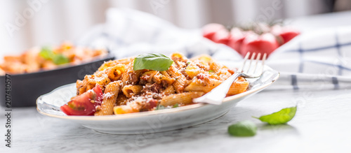 Italian food and pasta pene with bolognese sause on plate