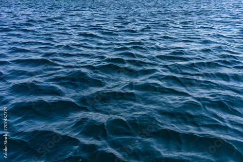 The water surface of the sea with small waves.