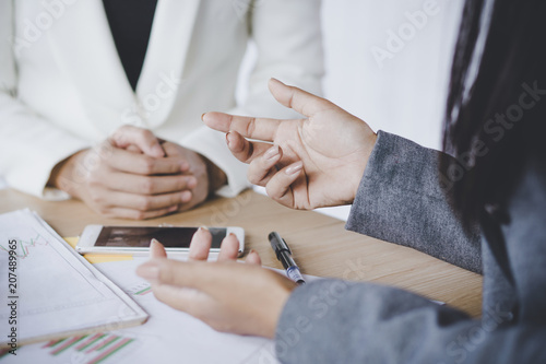 female business woman working together talking at office desk focus on hand 