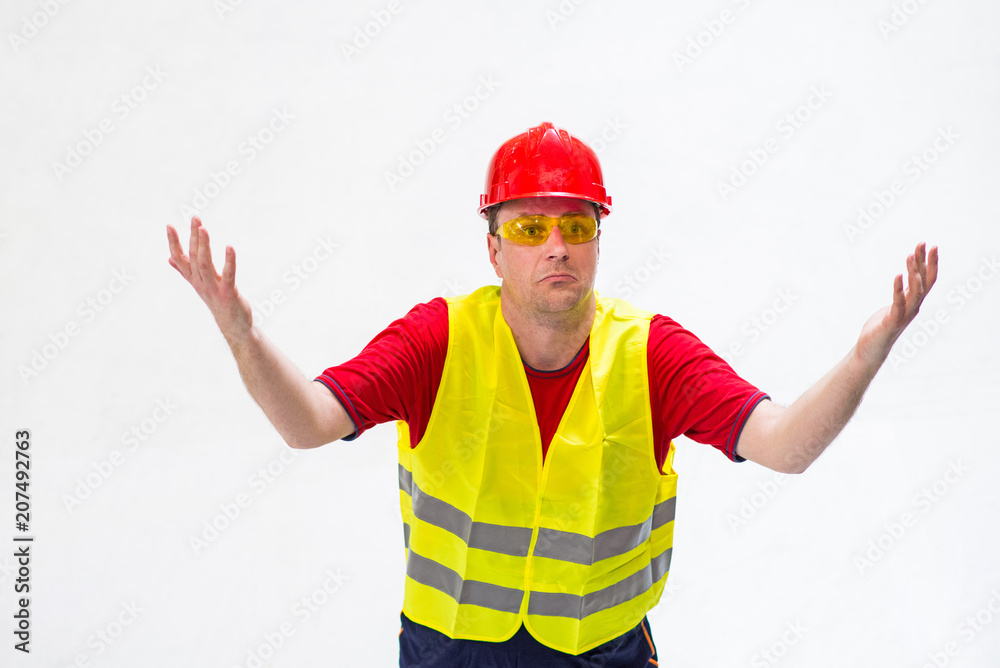 Confused factory worker expressing misunderstanding looking up in his boss. Surprised factory worker with his arms wide opened on white background looking up Confused factory worker expressing misunderstanding looking up in his boss. Surprised factory worker with his arms wide opened on white background looking up