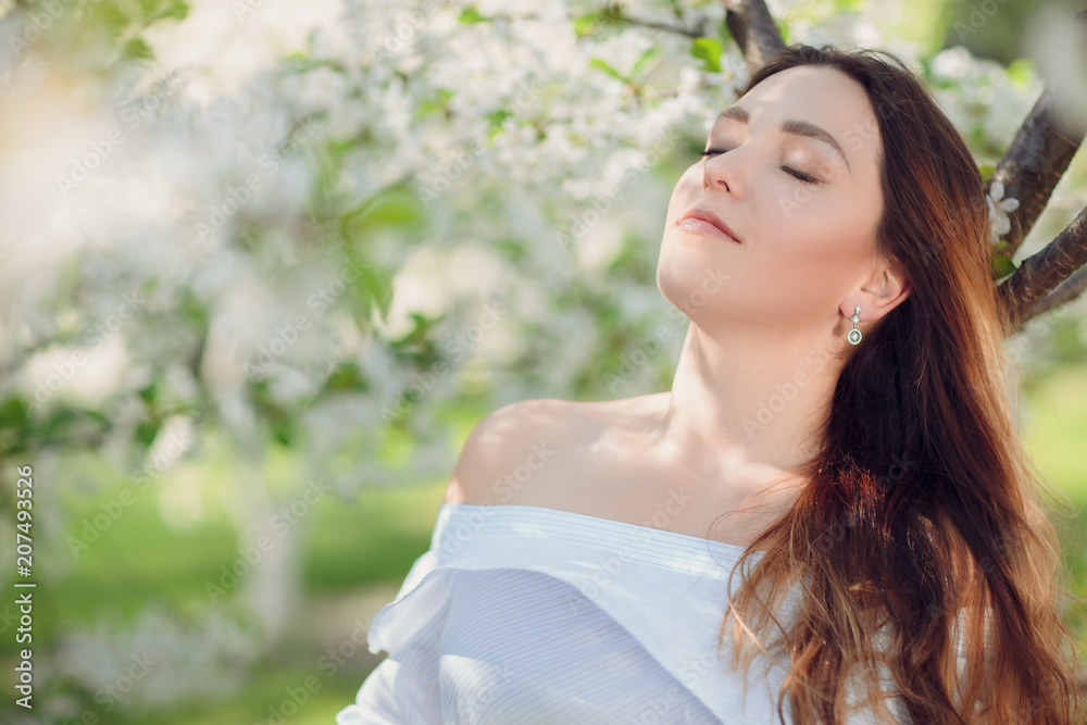Close up romantic portrait of beautiful elegant woman in blossom spring trees. Close up romantic portrait of beautiful elegant woman in blossom spring trees.