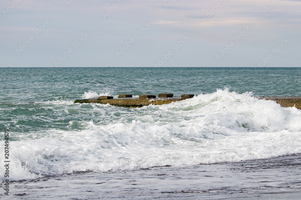 Waves on the sea near the pier overcast Waves on the sea near the pier overcast