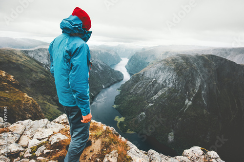 Weekend getaway Man wanderer traveling in Norway mountains standing on cliff healthy lifestyle adventure vacations aerial view Naeroyfjord landscape photo