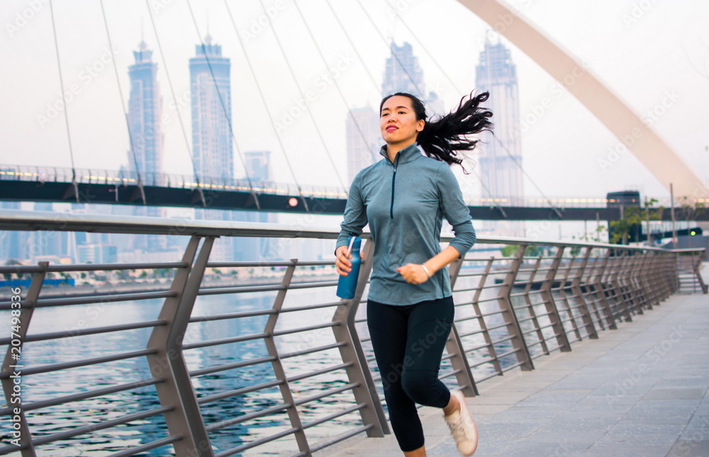 Girl running in a modern city environment