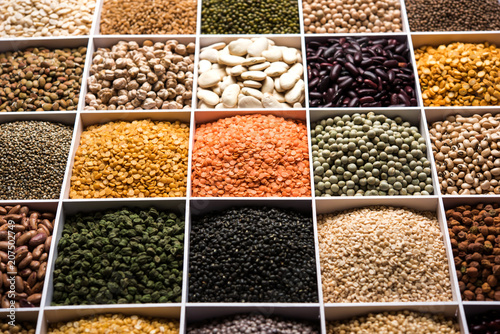 Indian Beans,Pulses,Lentils,Rice and Wheat grain in a white wooden box with cells, selective focus.