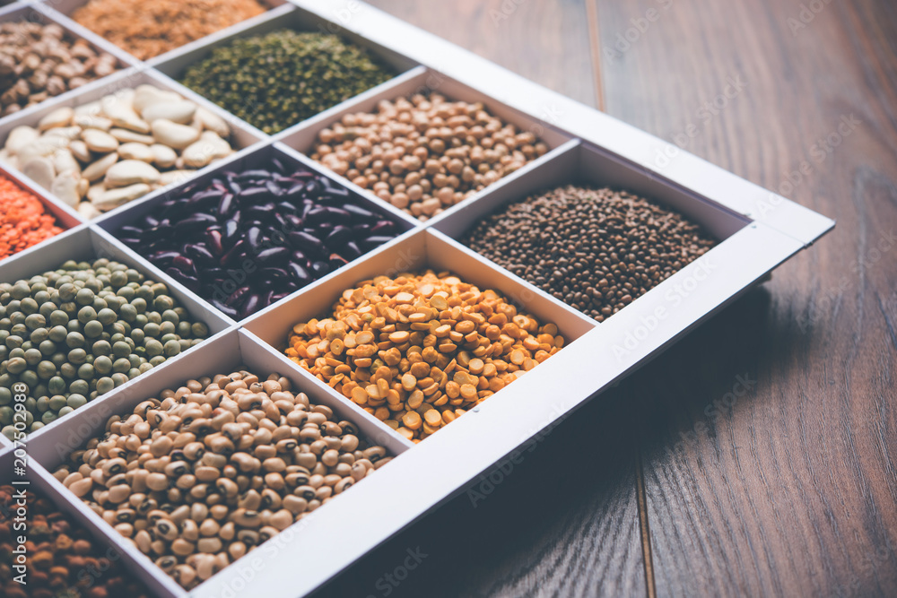 Indian Beans,Pulses,Lentils,Rice and Wheat grain in a white wooden box with cells, selective focus. Indian Beans,Pulses,Lentils,Rice and Wheat grain in a white wooden box with cells, selective focus.