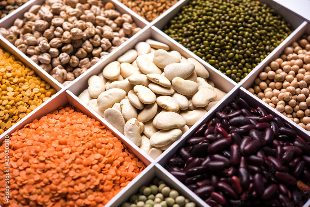 Indian Beans,Pulses,Lentils,Rice and Wheat grain in a white wooden box with cells, selective focus. Indian Beans,Pulses,Lentils,Rice and Wheat grain in a white wooden box with cells, selective focus.