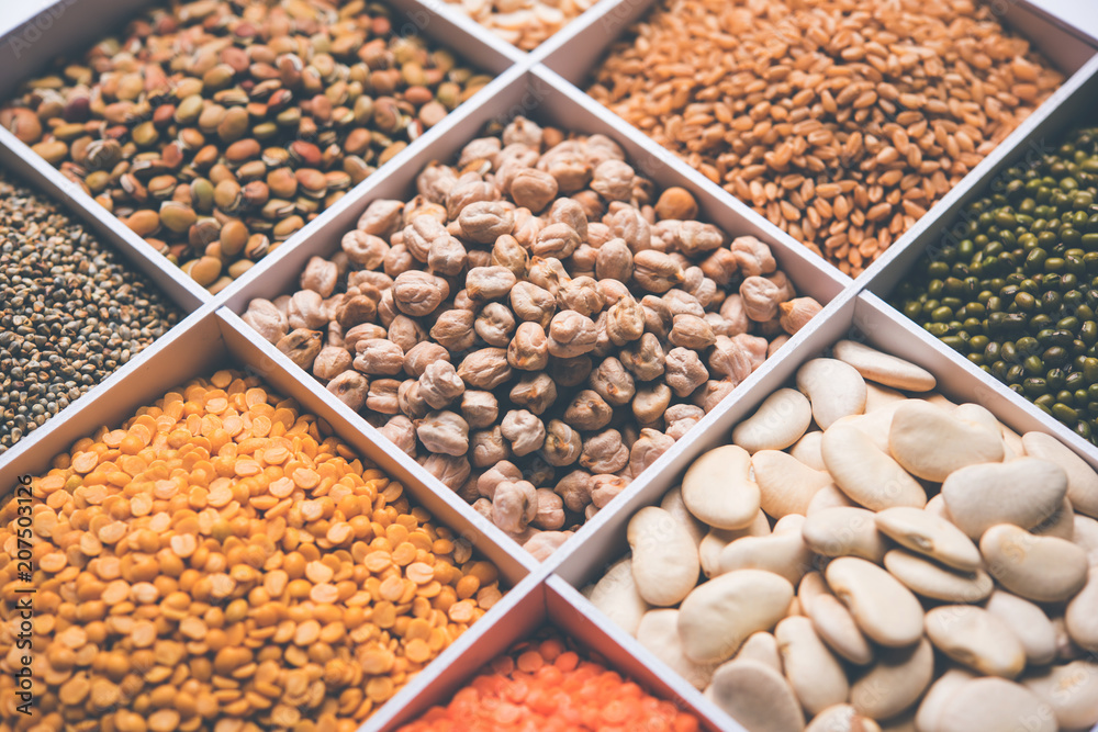 Indian Beans,Pulses,Lentils,Rice and Wheat grain in a white wooden box with cells, selective focus. Indian Beans,Pulses,Lentils,Rice and Wheat grain in a white wooden box with cells, selective focus.